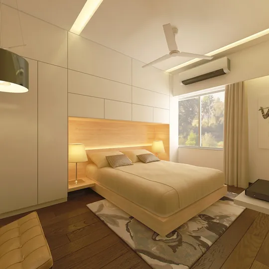 Bedroom with upholstered headboard wall and warm lighting