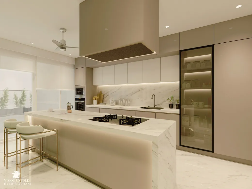Modular kitchen with marble-finish island, handleless beige cabinetry and a lit glass tall unit