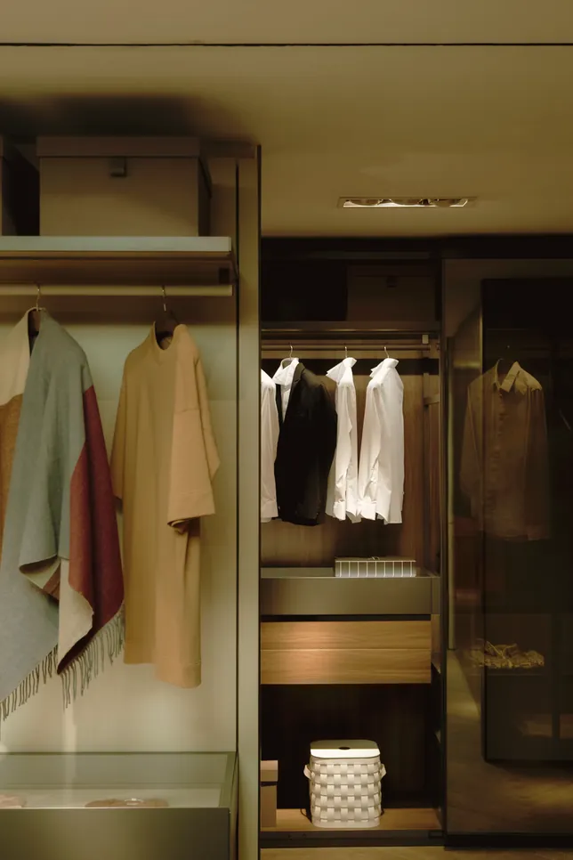 Dark wardrobe interior with hanging rail and drawers