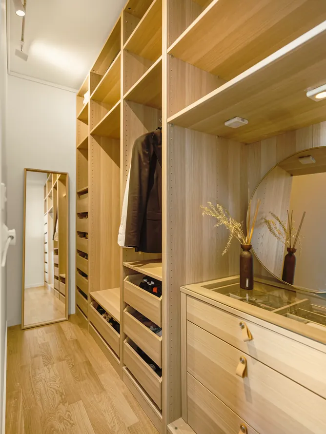 Open walk-in wardrobe with oak shelving and drawers